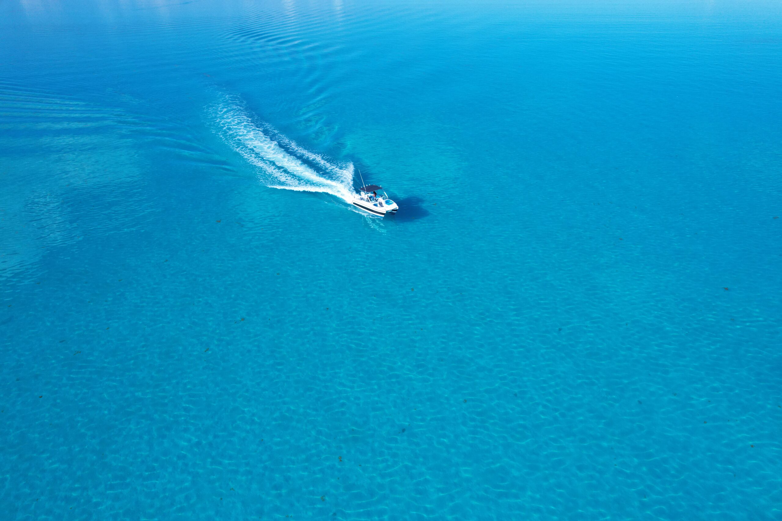 Private boat cruising over bright blue water in Turks and Caicos