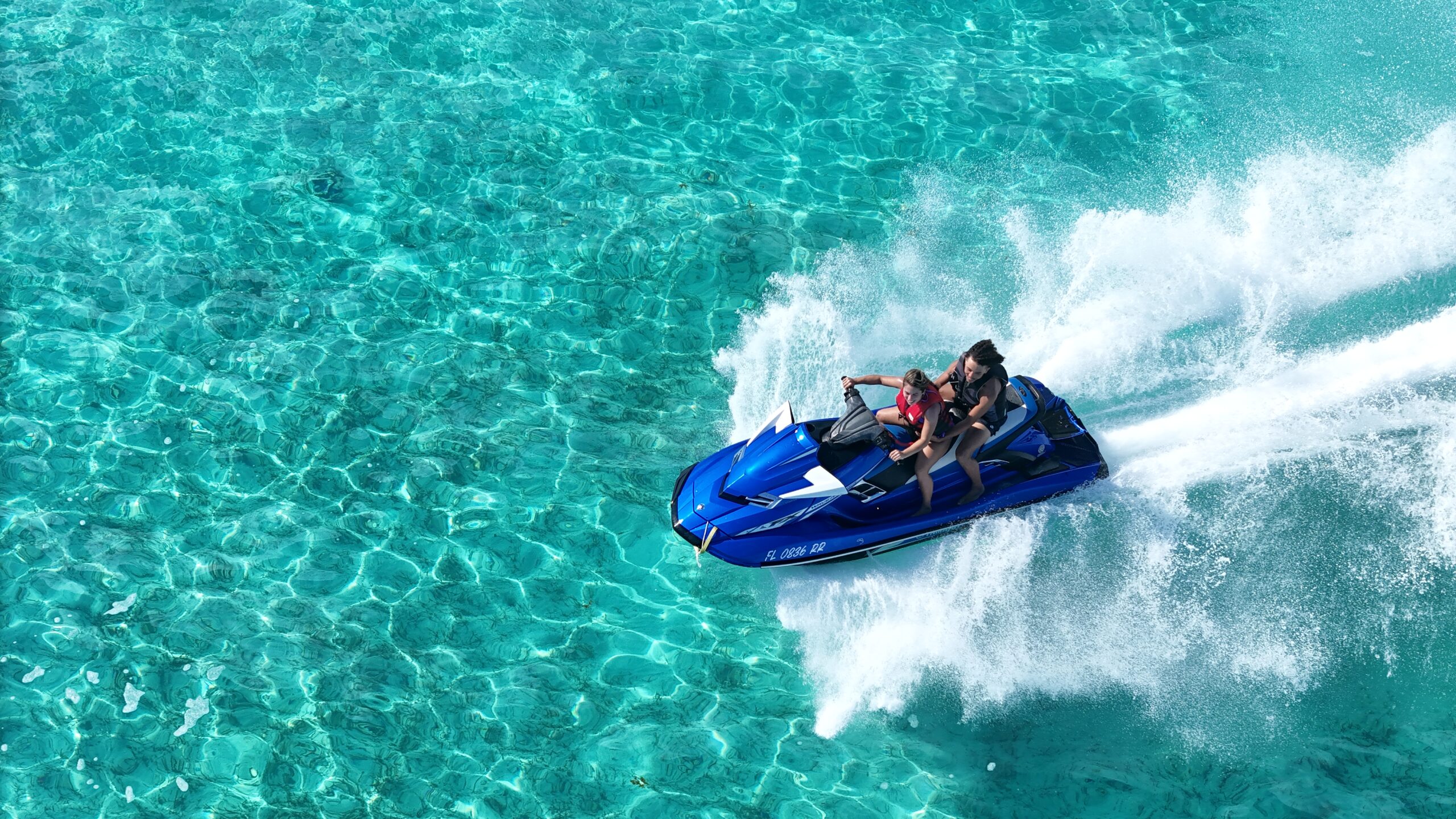 Jet Ski riding across clear water in Providenciales, Turks and Caicos